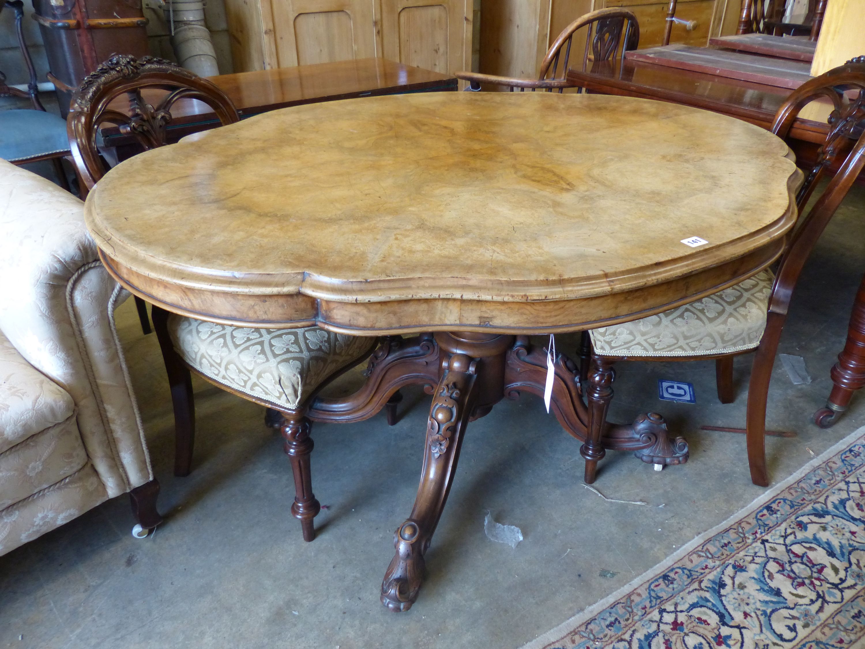 A Victorian figured walnut shaped oval tilt topped loo table, width 134cm, depth 102cm, height 73cm